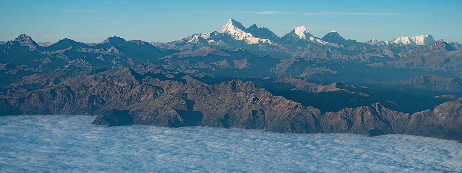 Snow-capped Bhutan Himalaya rising above a sea of cloud